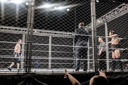 Cena vs Bryan inside a steel cage