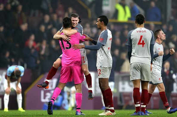 Alisson celebrates with James Milner