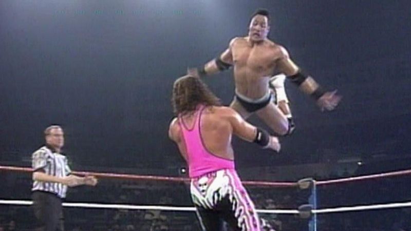 A rookie Rocky leaps from the top rope onto an irate Hitman.