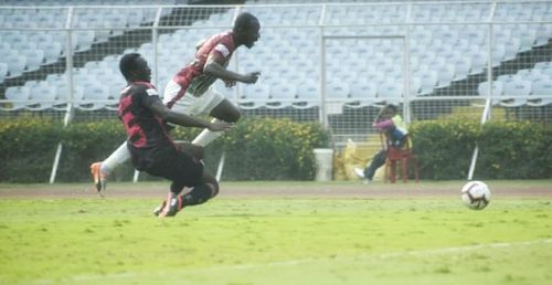 Dipanda Dicka being taken down by Lancine Toure during the match