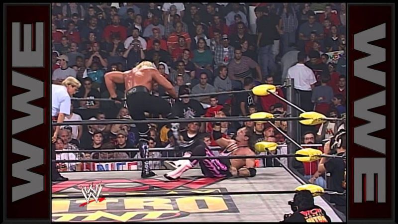 Hogan punishes the Hitman in the corner.