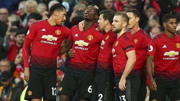 Manchester players celebrate a goal