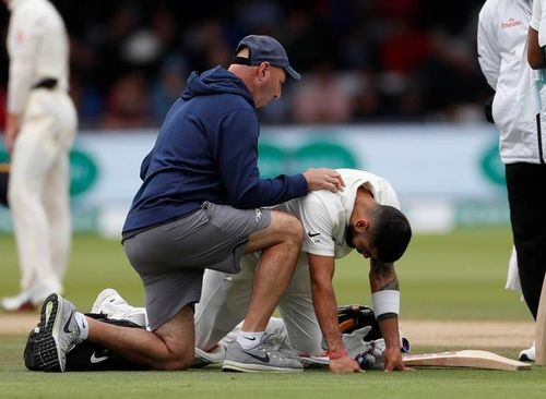 Virat Kohli receiving treatment on the field.