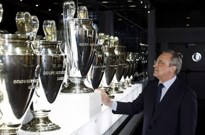 Real Madrid CF President Florentino Perez looks at the UEFA Champions League Trophy