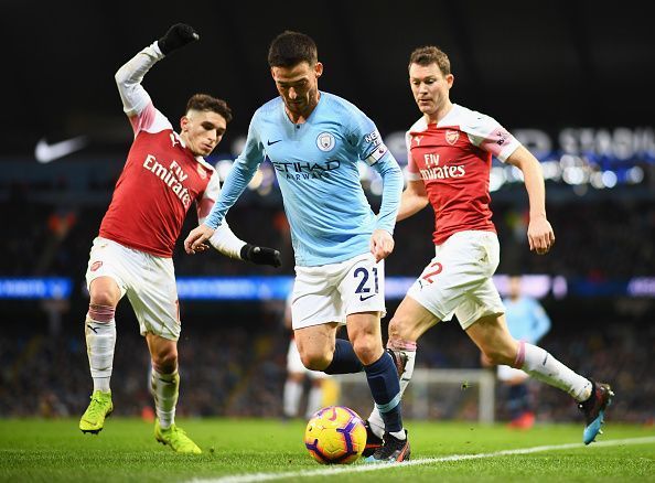 Stephan Lichtsteiner battles out with David Silva