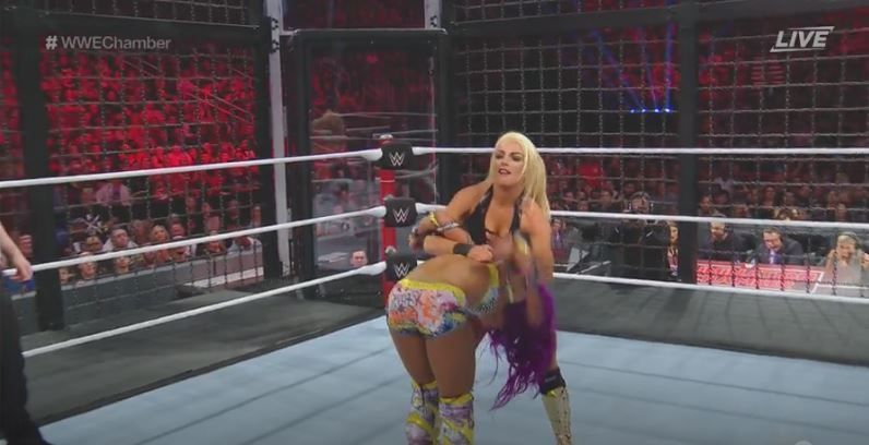 Mandy Rose performing the bed of roses on Sasha Banks.