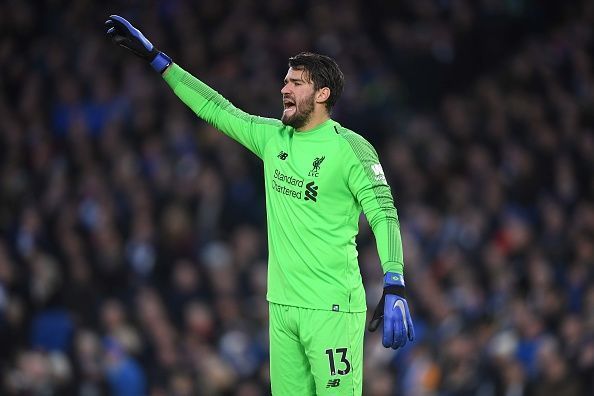 Alisson Becker plays against Brighton & Hove Albion in a Premier League game.