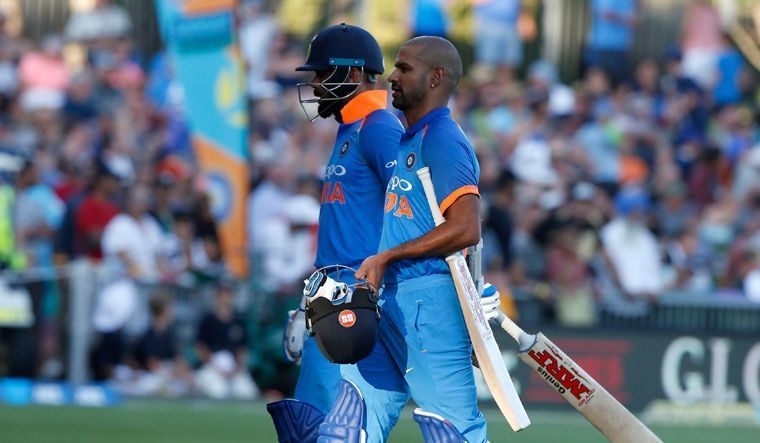 Kohli and Dhawan walking off the field as play was stopped due to excessive sunlight
