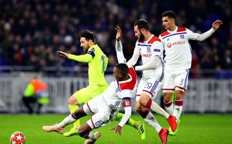 Lionel Messi under challenge by Marcelo, Lucas Tousart, and Houssem Aouar