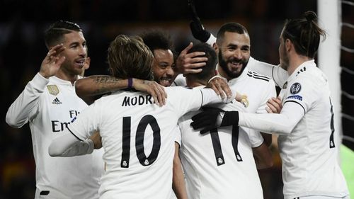 Real Madrid players celebrate a goal vs AS Roma in a UEFA Champions League group stage match