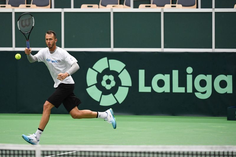 Czech Republic&#039;s Lukas Rosol training, with the La Liga logo in the background