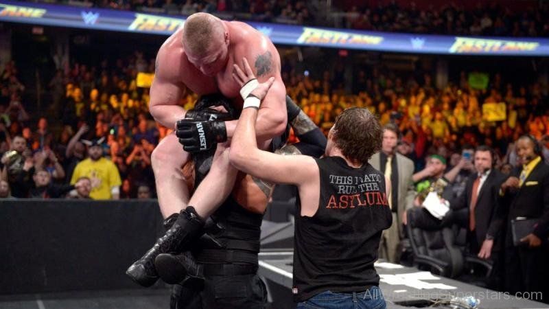 Roman and Dean Powerbomb Lesnar through announce table