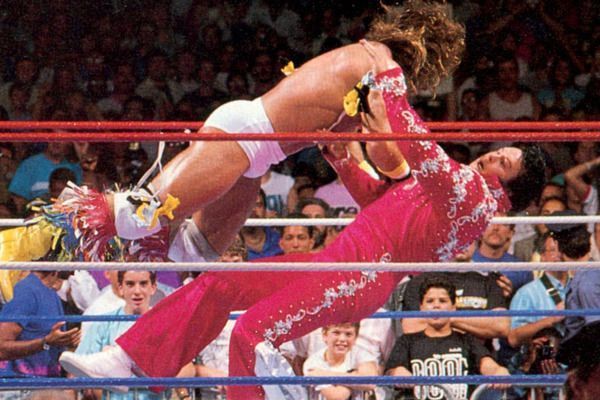 The Ultimate Warrior takes down Honky Tonk Man with a flying tackle