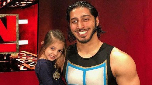 Mustafa Ali posing with his daughter