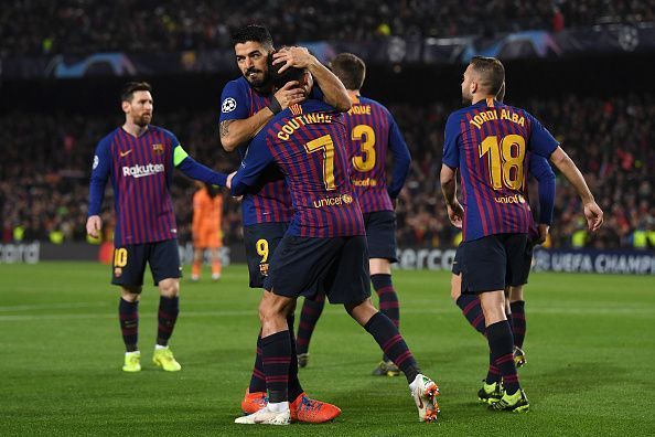 Suarez celebrates with Coutinho after teeing up the Brazilian at the end of a well-worked move