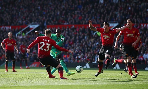 Phil Jones blocking a shot from Abdoulaye Doucoure