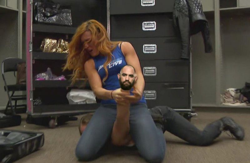 Becky Lynch photoshop where her victim&#039;s hand has been altered with Travis Browne&#039;s--aka Mr Ronda Rousey--head.