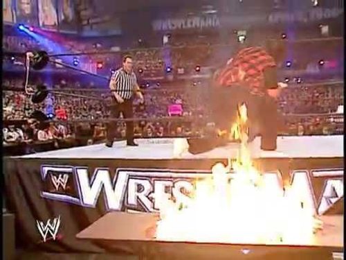 Edge spears Foley on fire