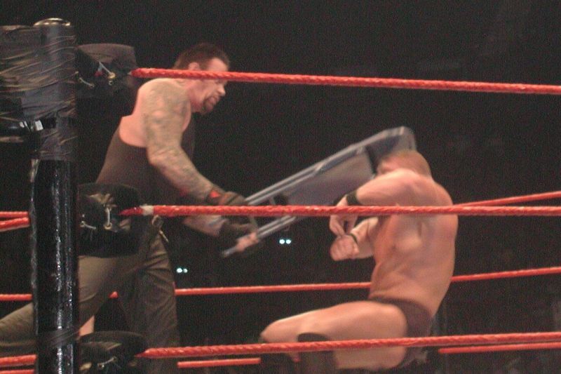 The Undertaker delivers a sickening chair shot to a young Brock Lesnar