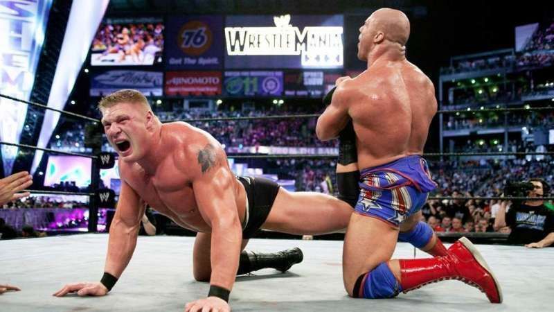 Angle applies his famous ankle lock on Brock