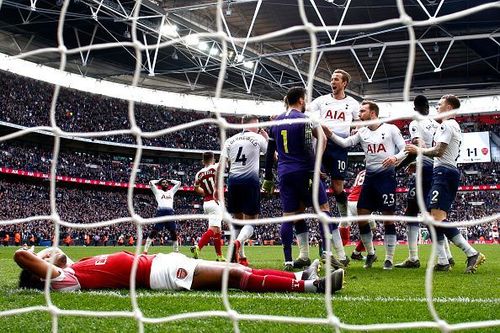 Tottenham players celebrate with Hugo Lloris after his penalty save to deny Aubameyang late on