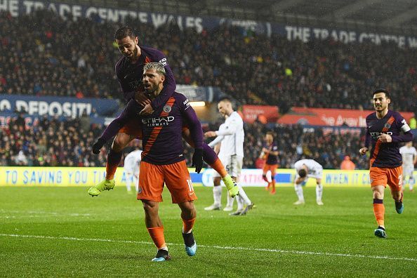 Aguero celebrates with both Bernardo and David Silva during City&#039;s 3-2 away win vs. Swansea