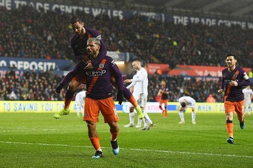 Aguero celebrates with both Bernardo and David Silva during City's 3-2 away win vs. Swansea