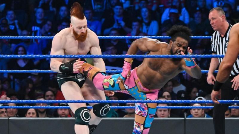 The New Day faced off against The Bar and RAW&#039;s Drew McIntyre, in a bout that saw WWE Champion Kofi Kingston get the pinfall victory.