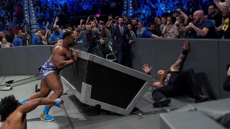 Big E hurls Rowan over the announce table, and New Day win via countout!