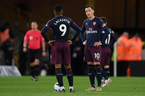 Alexandre Lacazette and Mesut Ozil look dejected after Arsenal's loss to Wolves