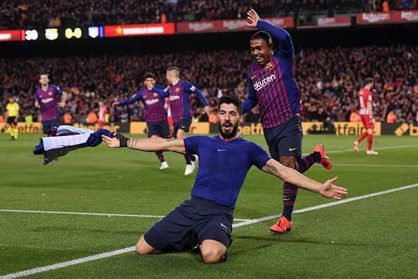 Suarez wheels away to celebrate Barca&#039;s first goal against ten-man Atletico Madrid