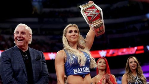 Charlotte Flair posing with the Raw Women's Title following her triumph