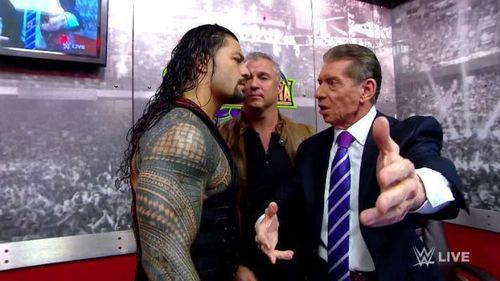 Roman Reigns with Shane and Vince McMahon