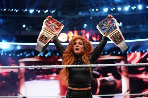 Becky Lynch holding both the RAW and Smackdown Live Women's Championships at WrestleMania 35