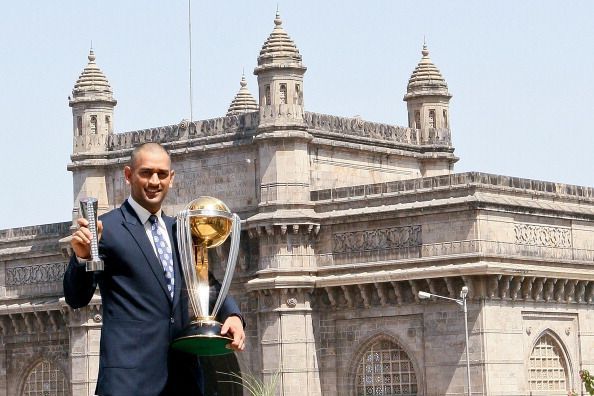 Dhoni posing with the World Cup trophy in Mumbai