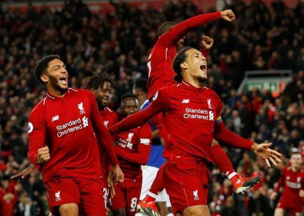 Liverpool defender Virgil Van Dijk celebrates as Liverpool score a 93rd minute winner against city rivals Everton