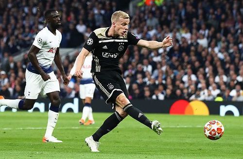 Ajax's van de Beek scores the only goal of the game as Tottenham players look on.