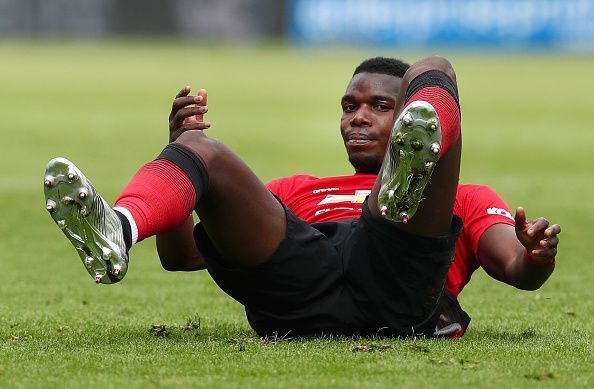 Paul Pogba looks to get up after a fall during the game.