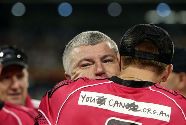 A grey-haired MacGill is hugged by Dominic Thornely after the BBL win