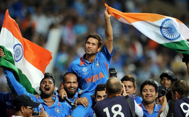 Sachin Tendulkar, carried by his teammates waves the Indian flag after India won the 2019 Cricket World Cup final in Mumbai on 02 April 2011 (&Acirc;&copy; William West, AFP/Getty Images).