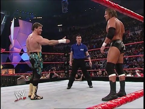 Eddie extending his hand to Triple H