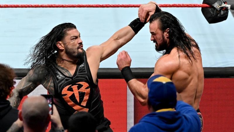 Roman Reigns delivers a stiff right hand to Drew McIntyre as the two men continue to brawl outside the ring on an episode of RAW