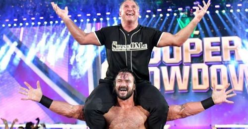 Shane McMahon celebrating with Drew Mcintyre