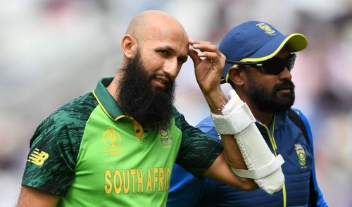 Amla walks back after being hit on the helmet