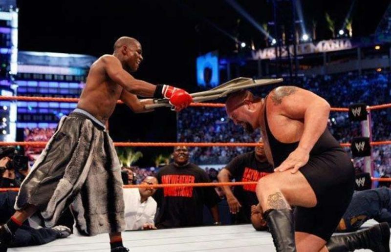 Floyd Mayweather smashes Big Show with a steel chair.