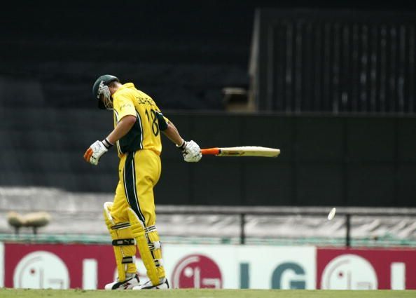 Adam Gilchrist of Australia shows his disappointment after being run out for 99