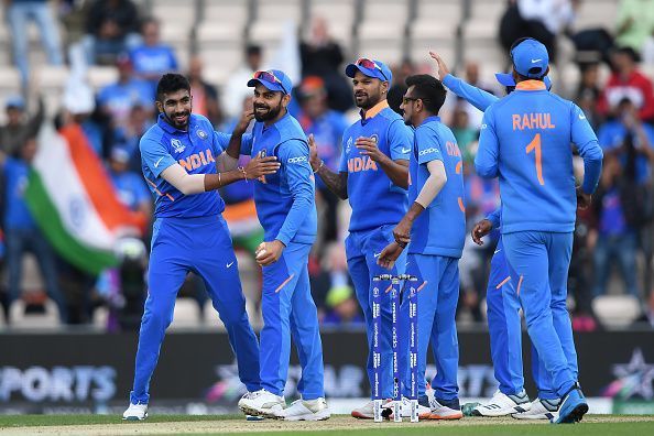 The Indian Team celebrates the fall of a wicket