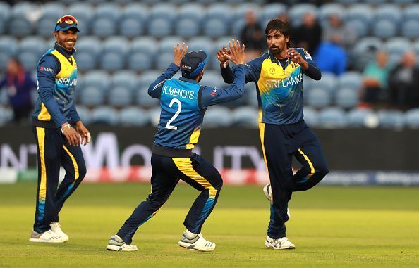 Nuwan Pradeep (right) celebrates the fall of a wicket.