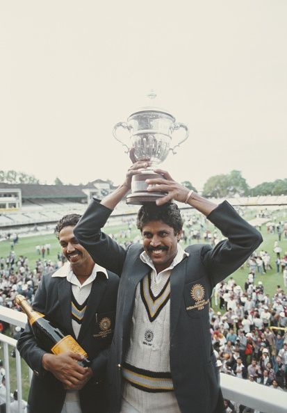 Skipper Kapil Dev jubilantly holds aloft the Prudential World Cup 1983 trophy as man-of-the-match Mohinder Amarnath revels in the moment.