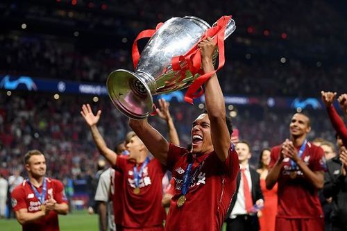 Trent Alexander-Arnold celebrates with the UEFA Champions League trophy after Liverpool's win on June 1